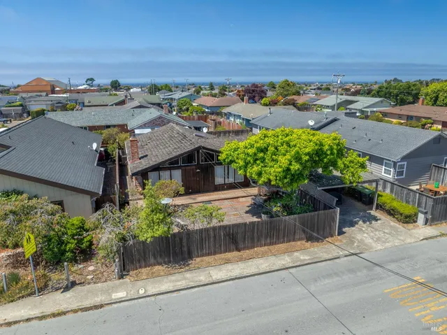 aerial view of a house with a yard and garden