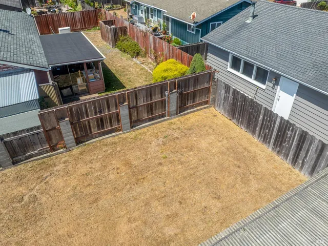 an aerial view of a house with a yard basket ball court and outdoor seating
