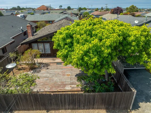 a view of a balcony with two chairs and a table