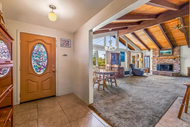 a view of a porch with furniture and a grill