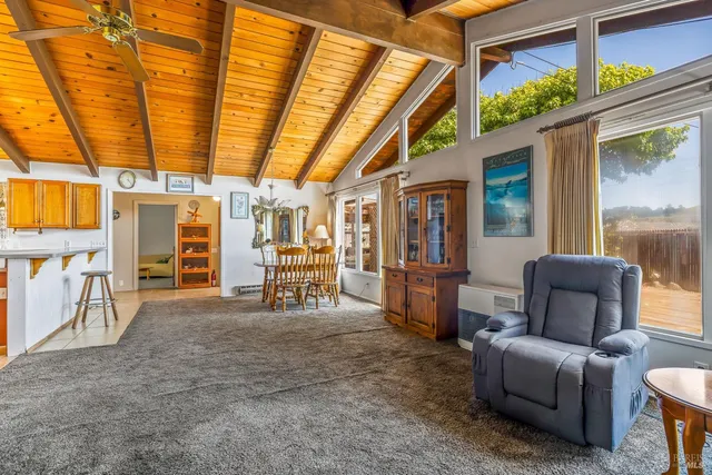 a view of kitchen with furniture and refrigerator