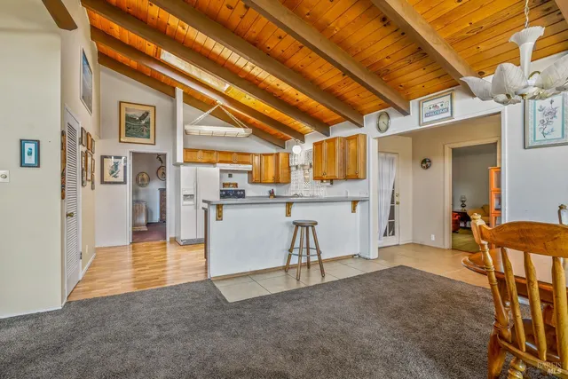 a view of a kitchen with stainless steel appliances granite countertop a sink and cabinets