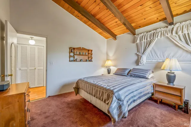 a bathroom with a granite countertop double vanity sink and mirror