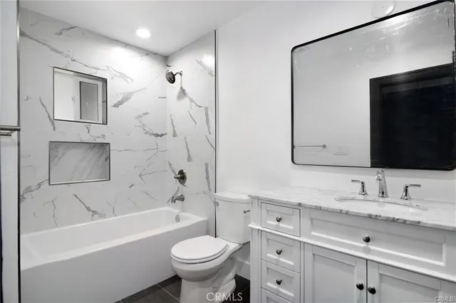 a bathroom with a sink a toilet and bathtub