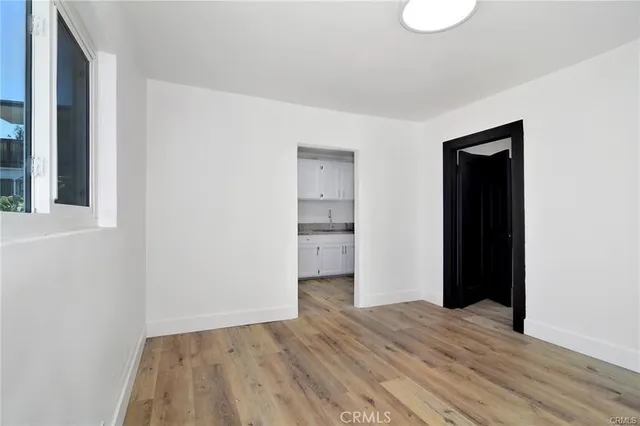 a view of a room with wooden floor and bathroom