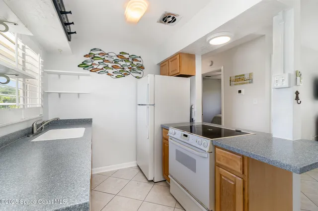 a utility room with a sink a window and appliances