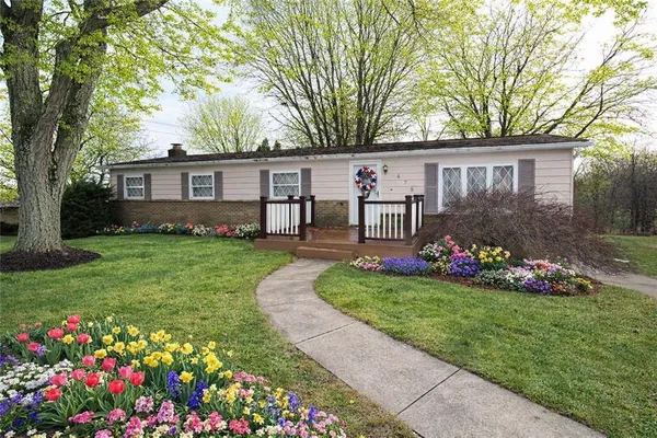 a front view of house with yard and outdoor seating