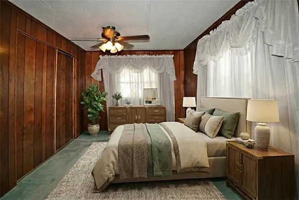 a bedroom with a bed and a chandelier