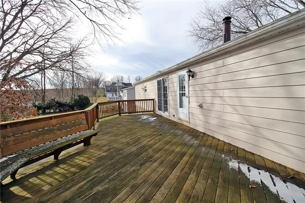 a view of a balcony with wooden floor and fence