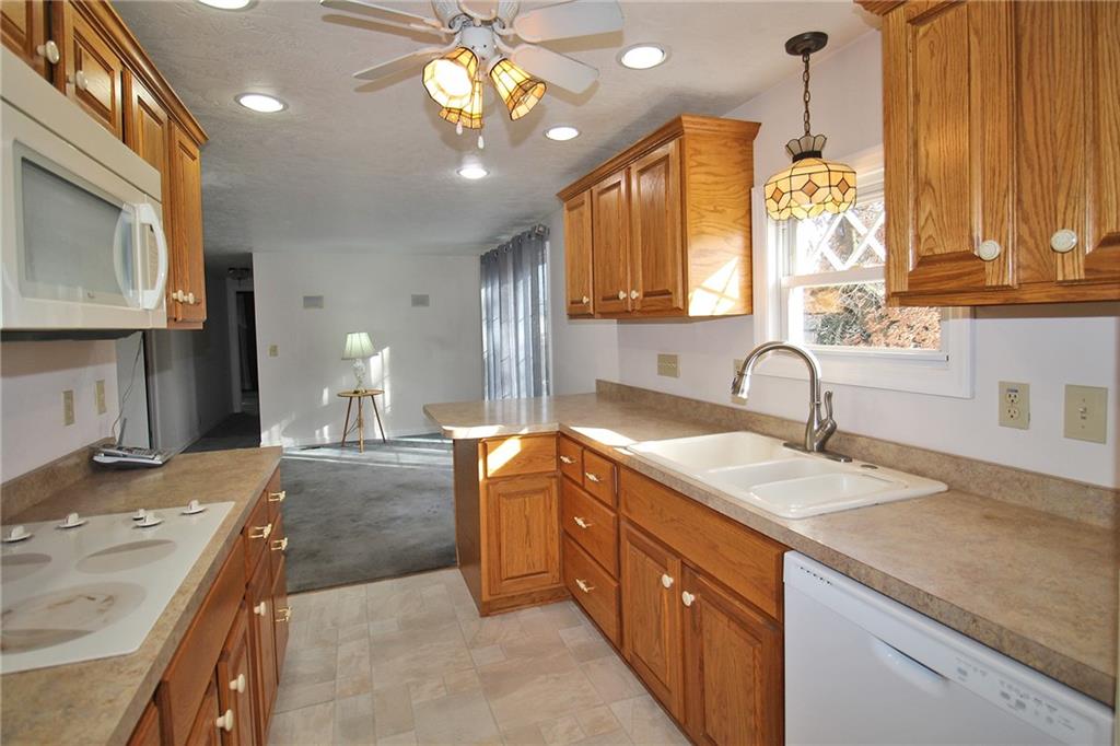 478 Cecil-Henderson Road Cecil, PA 15321 - Photo 3 of 26 a kitchen with a sink stove and cabinets