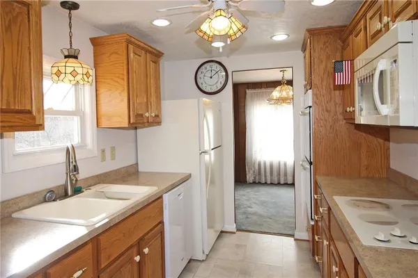 a bathroom with a granite countertop sink a large mirror and a shower