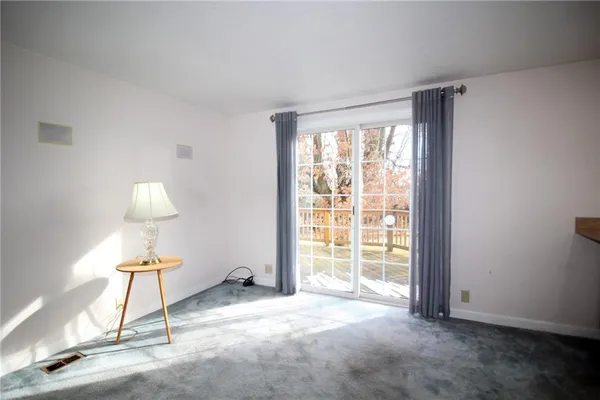 a view of a room with gym equipment and a window
