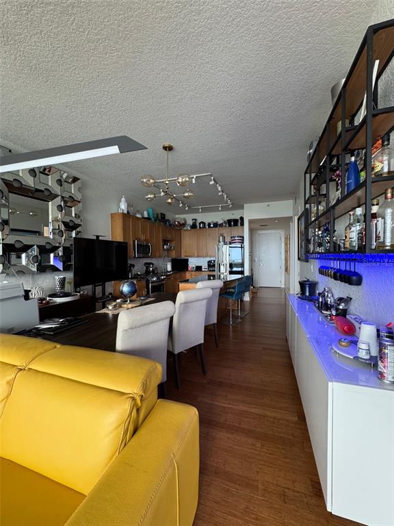 150 East Robinson Street, Unit 2409 Orlando, FL 32801 - Photo 17 of 26 a living room with furniture and a flat screen tv