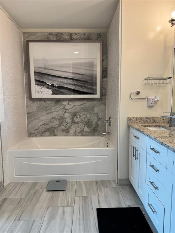 150 East Robinson Street, Unit 2409 Orlando, FL 32801 - Photo 19 of 26 a bathroom with a granite countertop sink toilet and bathtub