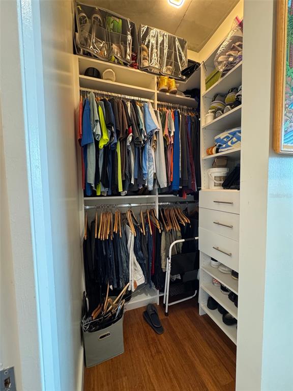 150 East Robinson Street, Unit 2409 Orlando, FL 32801 - Photo 20 of 26 a view of walk in closet with clothes and shoes
