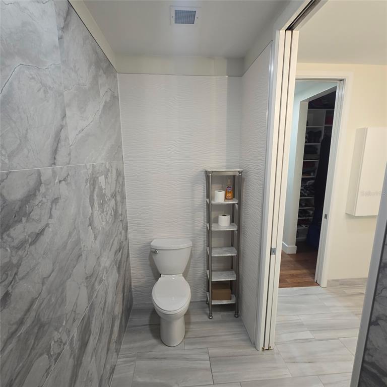 150 East Robinson Street, Unit 2409 Orlando, FL 32801 - Photo 4 of 26 a white toilet sitting next to a white cabinet