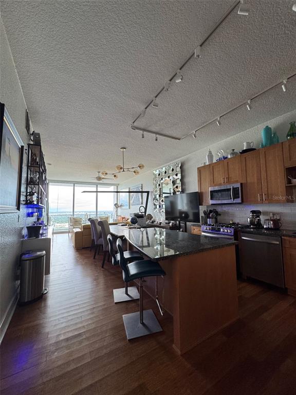 150 East Robinson Street, Unit 2409 Orlando, FL 32801 - Photo 8 of 26 a living room with fireplace furniture and a flat screen tv