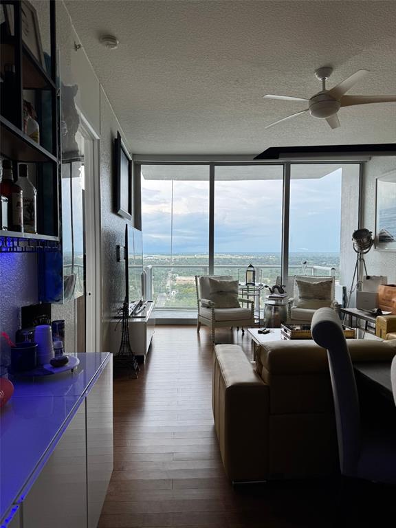 150 East Robinson Street, Unit 2409 Orlando, FL 32801 - Photo 9 of 26 a living room with fireplace furniture and a floor to ceiling window