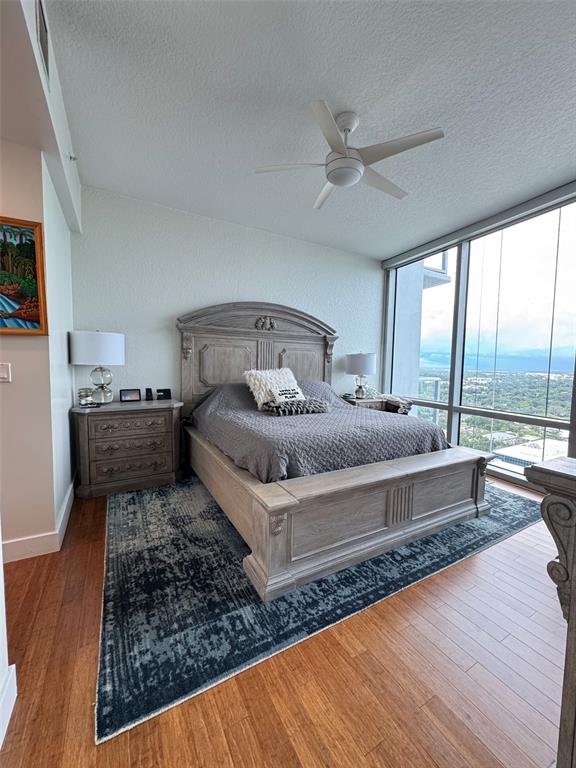 150 East Robinson Street, Unit 2409 Orlando, FL 32801 - Photo 10 of 26 a bedroom with a large bed and a large window