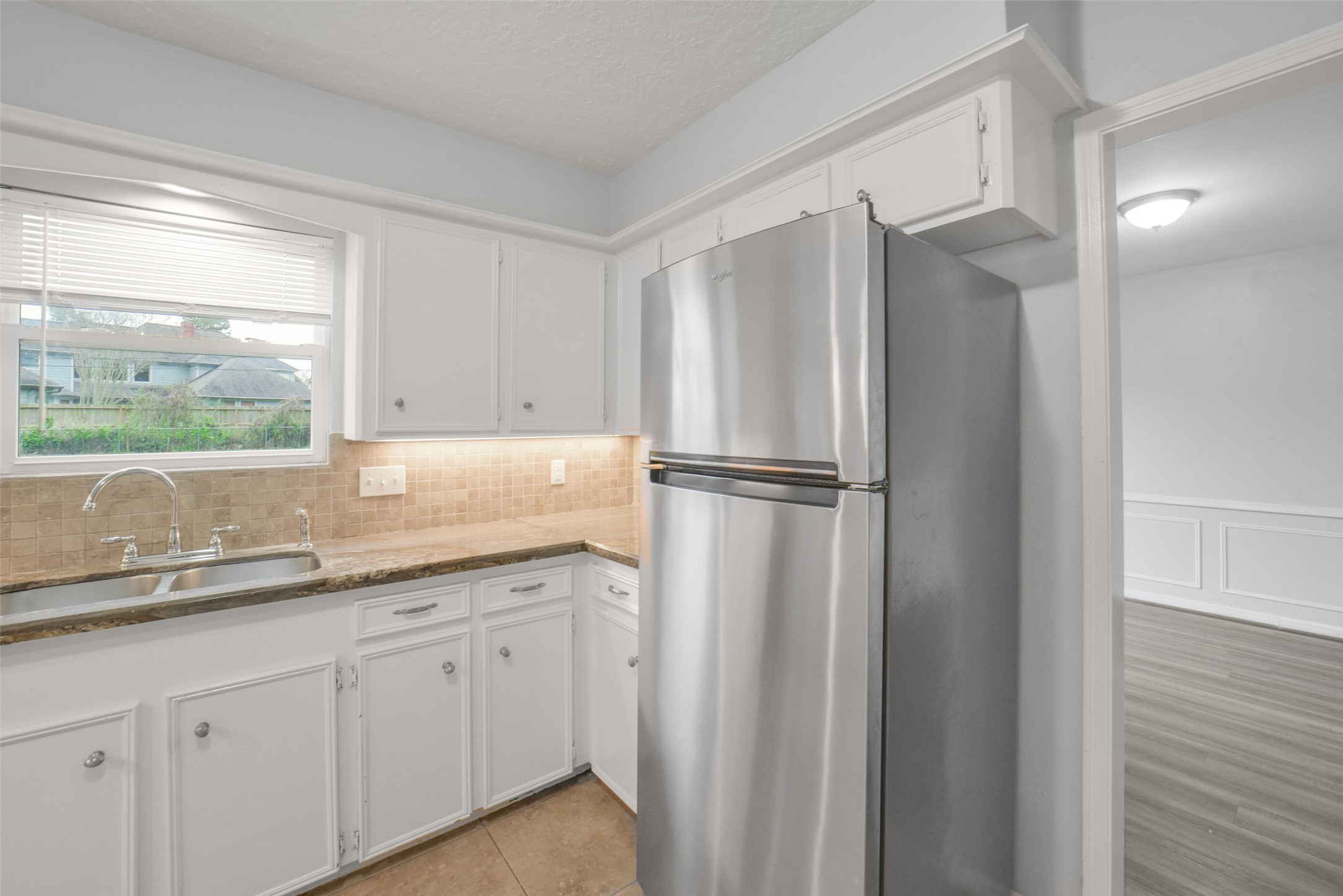 7611 Theisswood Road Spring, TX 77379 - Photo 12 of 41 a kitchen with a sink and a refrigerator