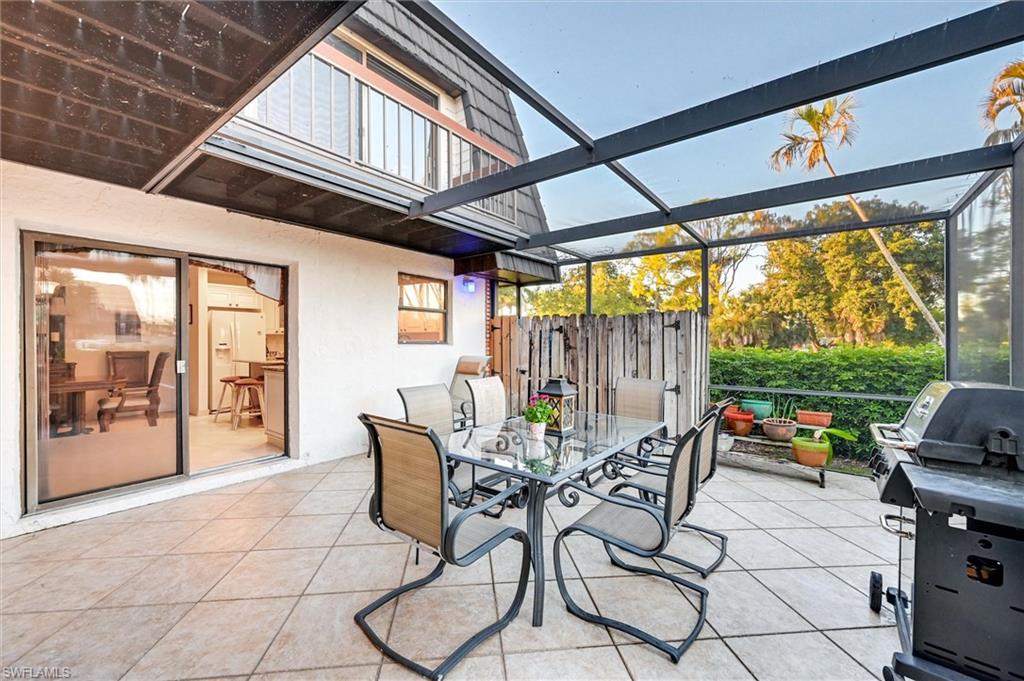 185 Lake Point Lane, Unit 8B Naples, FL 34112 - Photo 13 of 34 a outdoor space with patio the couches and a dining table with the garden view
