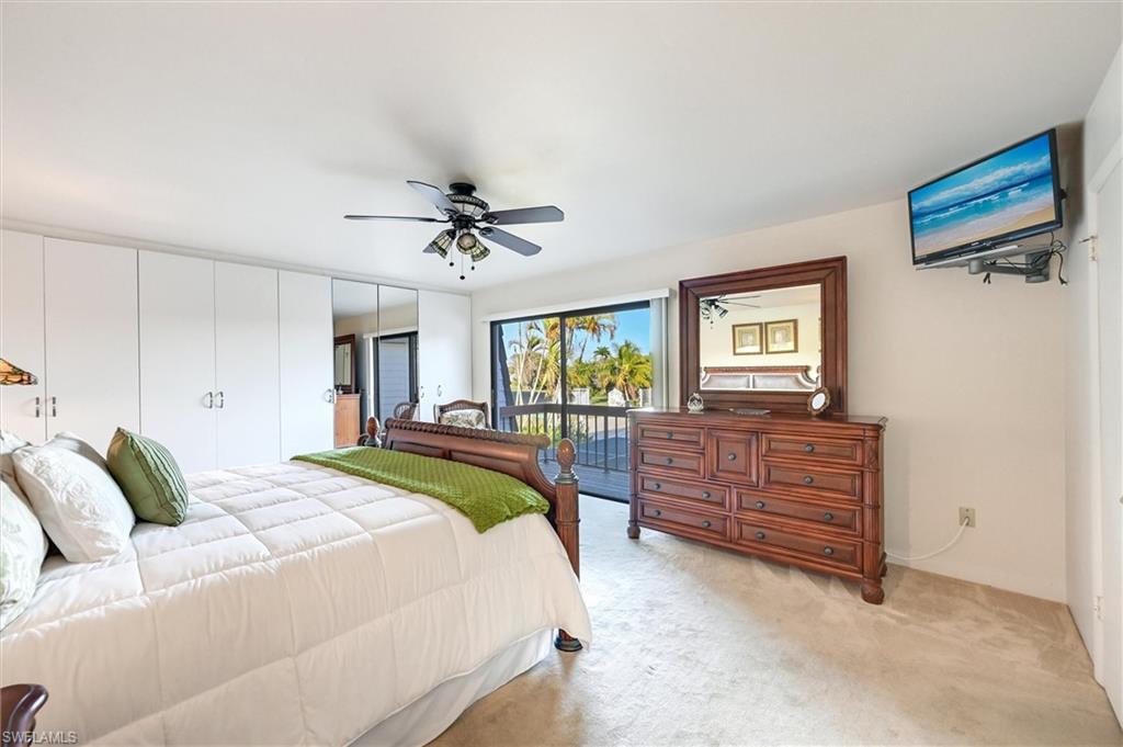 185 Lake Point Lane, Unit 8B Naples, FL 34112 - Photo 18 of 34 a bed room with a bed and a window