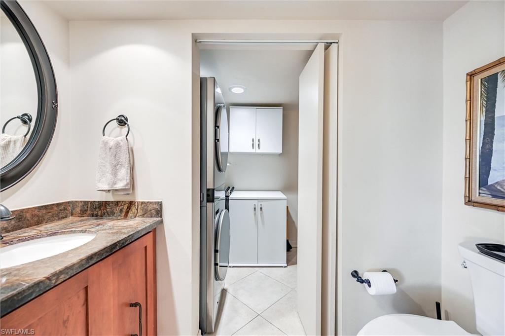 185 Lake Point Lane, Unit 8B Naples, FL 34112 - Photo 29 of 34 a bathroom with a granite countertop sink and a mirror