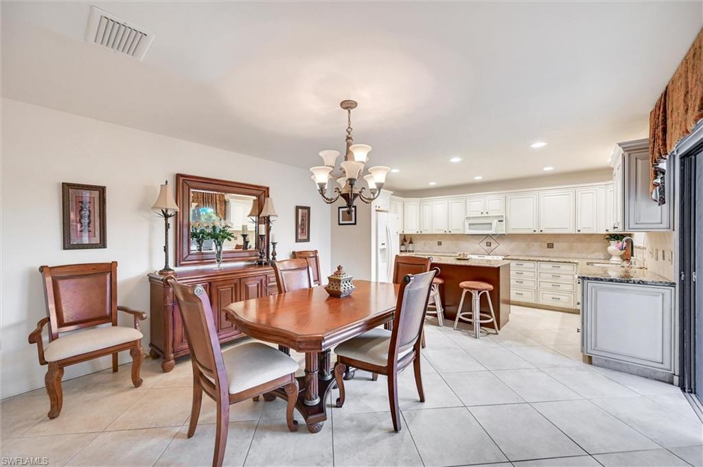 185 Lake Point Lane, Unit 8B Naples, FL 34112 - Photo 9 of 34 a dining room with furniture and window