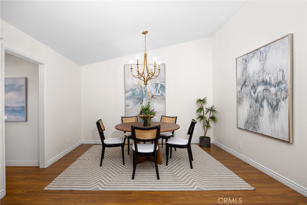 751 Ocean View Avenue, Unit A Monrovia, CA 91016 - Photo 13 of 29 a view of a dining room with furniture wooden floor and a chandelier