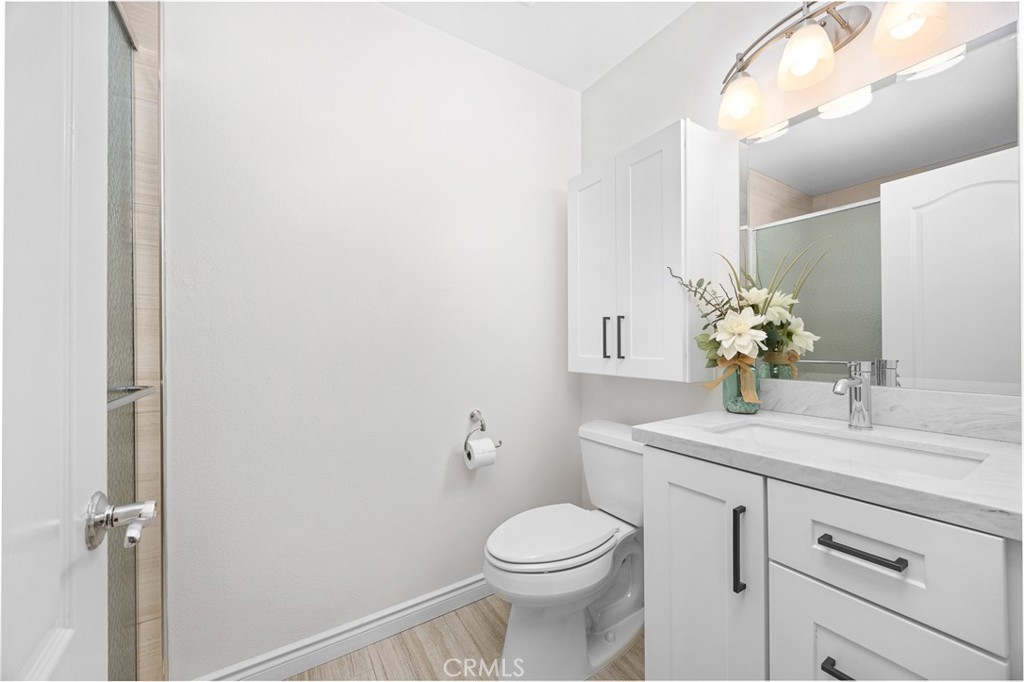 751 Ocean View Avenue, Unit A Monrovia, CA 91016 - Photo 23 of 29 a bathroom with a sink a toilet and a mirror