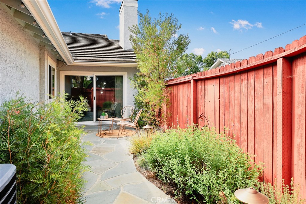 751 Ocean View Avenue, Unit A Monrovia, CA 91016 - Photo 25 of 29 a view of a house with potted plants and a bench