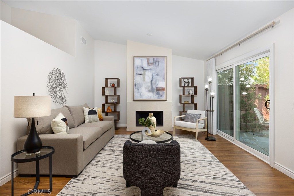 751 Ocean View Avenue, Unit A Monrovia, CA 91016 - Photo 9 of 29 a living room with furniture a fireplace and a floor to ceiling window