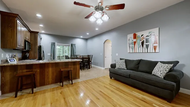 a living room with furniture and a wooden floor