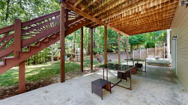 a view of a patio with a table chairs and a backyard