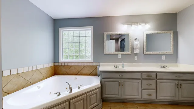 a bathroom with a bathtub a sink and a window