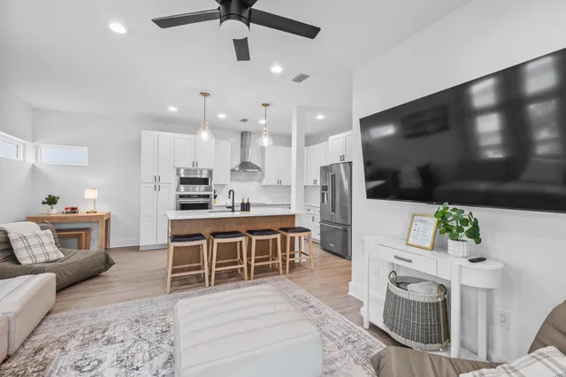 a bedroom with a large bed and a chandelier