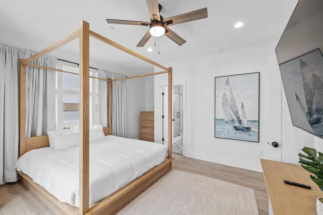 a bedroom with a bed and a chandelier