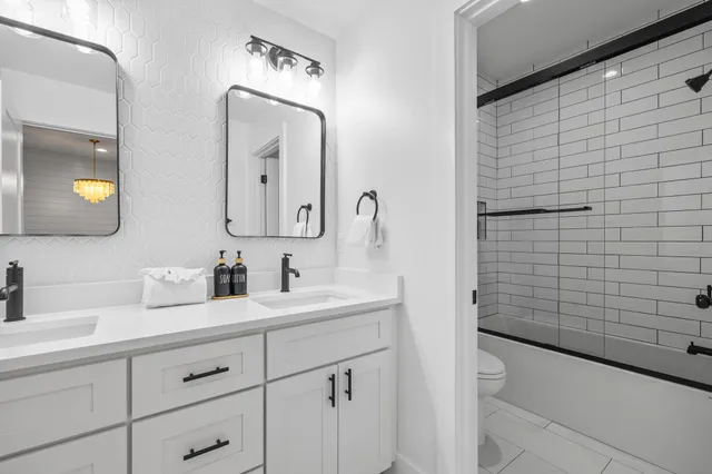 a bath room with a sink a bathtub and a shower