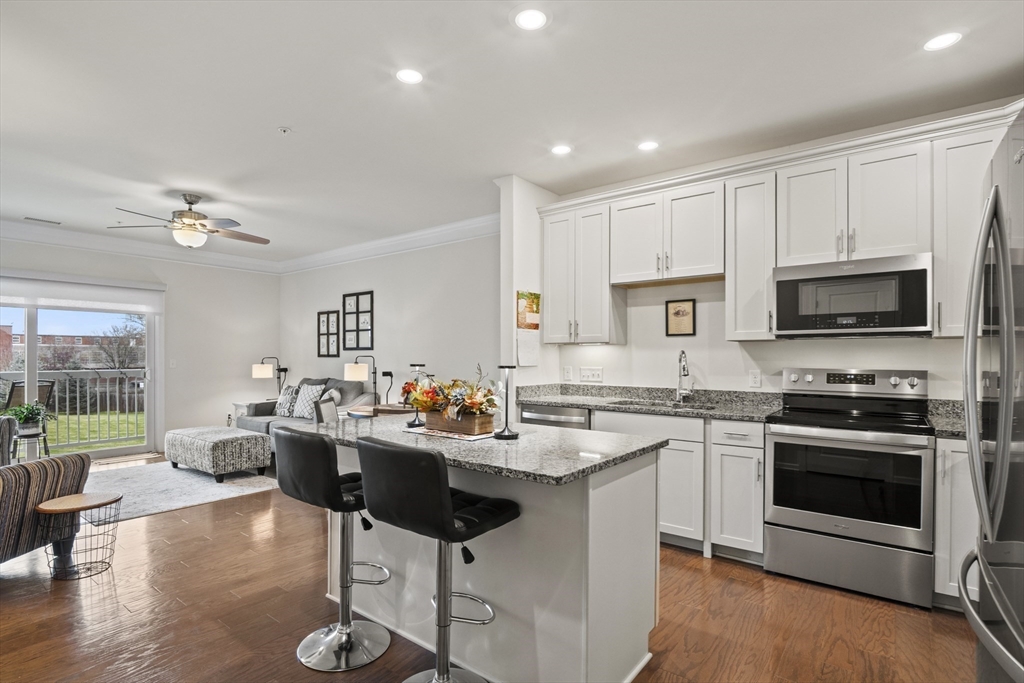 2 Talbot Way, Unit 2208 Westborough, MA 01581 - Photo 2 of 41 a kitchen with a sink stainless steel appliances and cabinets
