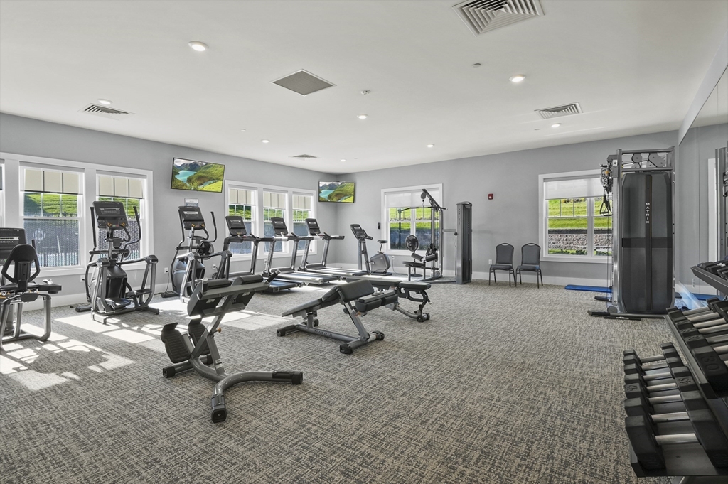 2 Talbot Way, Unit 2208 Westborough, MA 01581 - Photo 40 of 41 a living room filled with furniture gym equipment and a large window