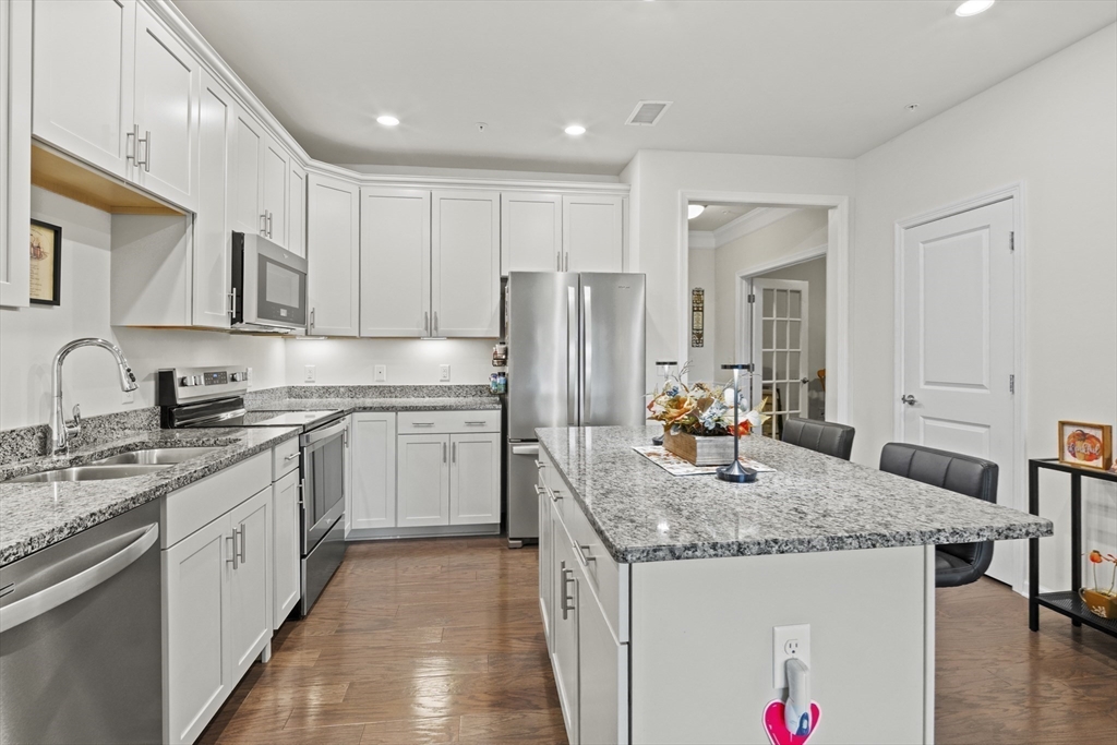 2 Talbot Way, Unit 2208 Westborough, MA 01581 - Photo 5 of 41 a kitchen with stainless steel appliances granite countertop a sink stove and refrigerator