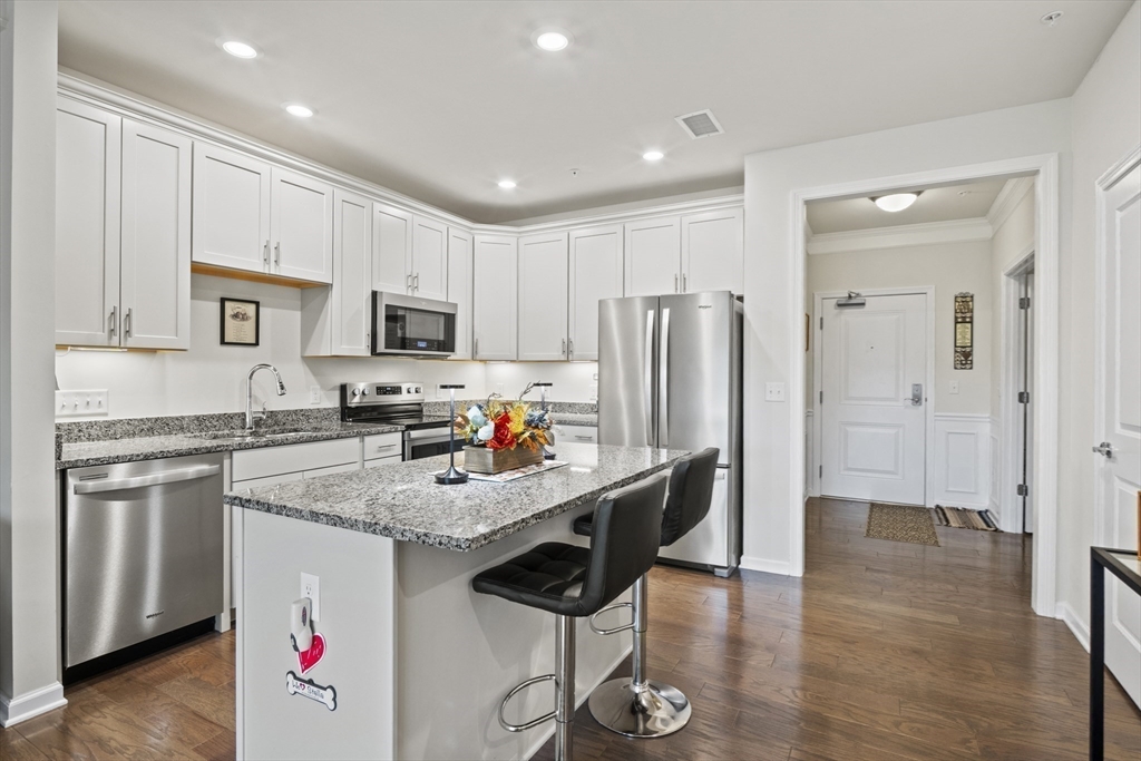 2 Talbot Way, Unit 2208 Westborough, MA 01581 - Photo 9 of 41 a kitchen with stainless steel appliances granite countertop a refrigerator stove microwave and sink