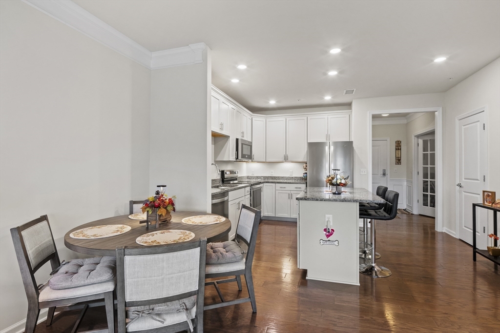 2 Talbot Way, Unit 2208 Westborough, MA 01581 - Photo 10 of 41 a kitchen with a dining table chairs and wooden floor