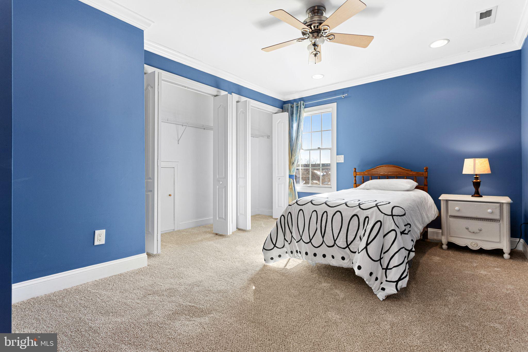 156 Ardmore Avenue Haddonfield, NJ 08033 - Photo 27 of 36 a spacious bedroom with a bed and a chandelier
