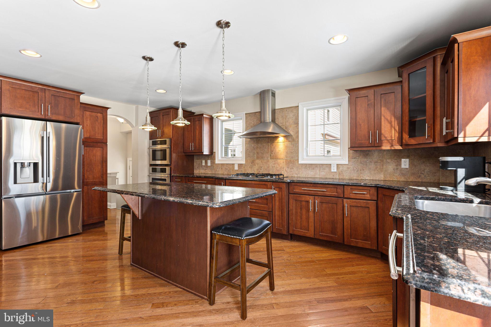 156 Ardmore Avenue Haddonfield, NJ 08033 - Photo 9 of 36 a kitchen with stainless steel appliances granite countertop wooden cabinets a stove a sink and a wooden floors