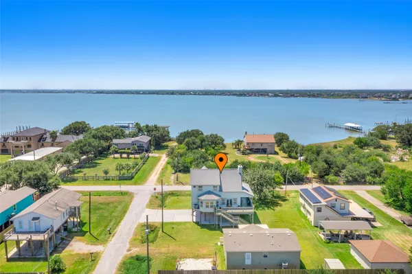 an aerial view of a house with a ocean view