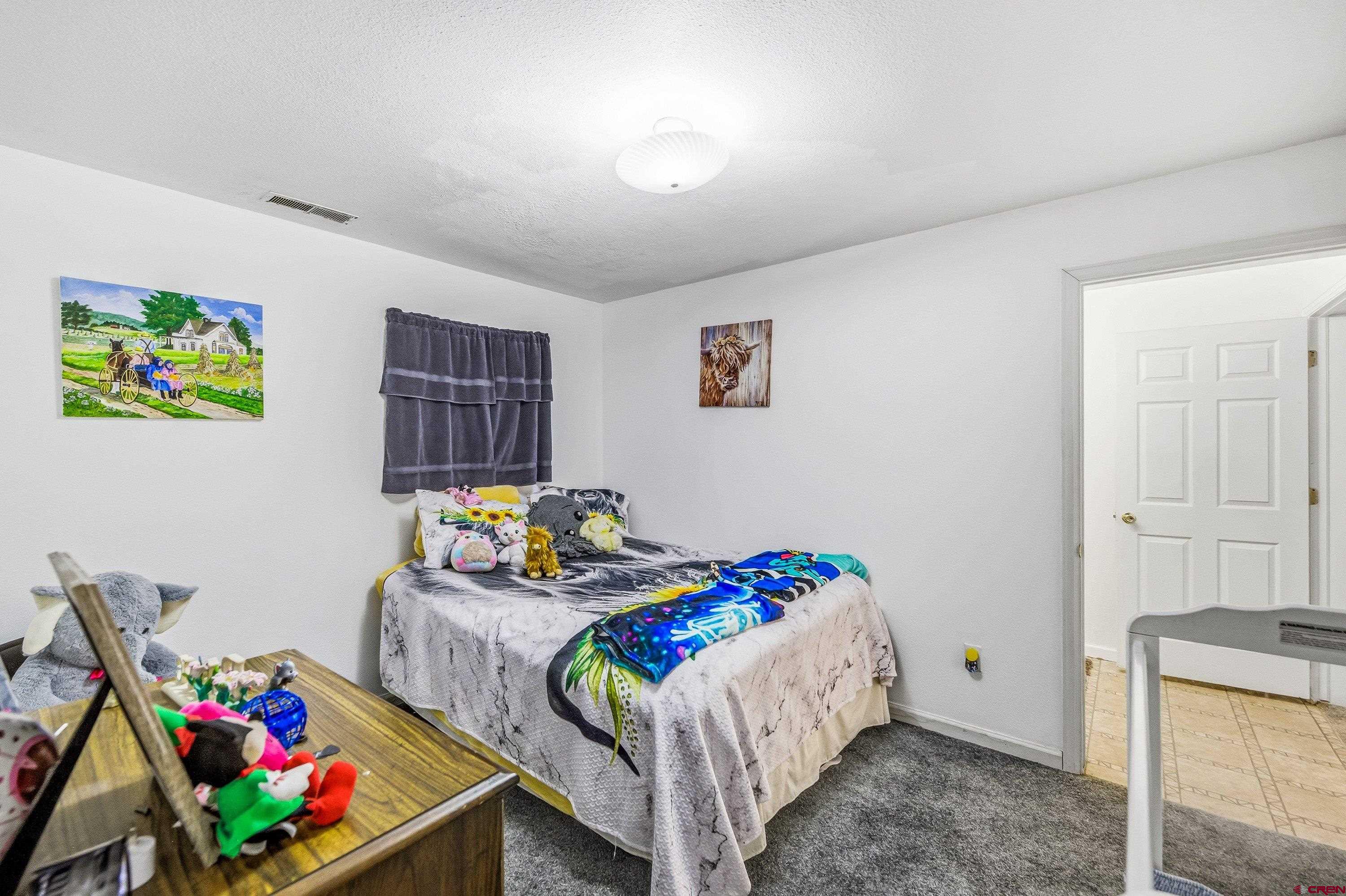 a bedroom with a bed and a dresser