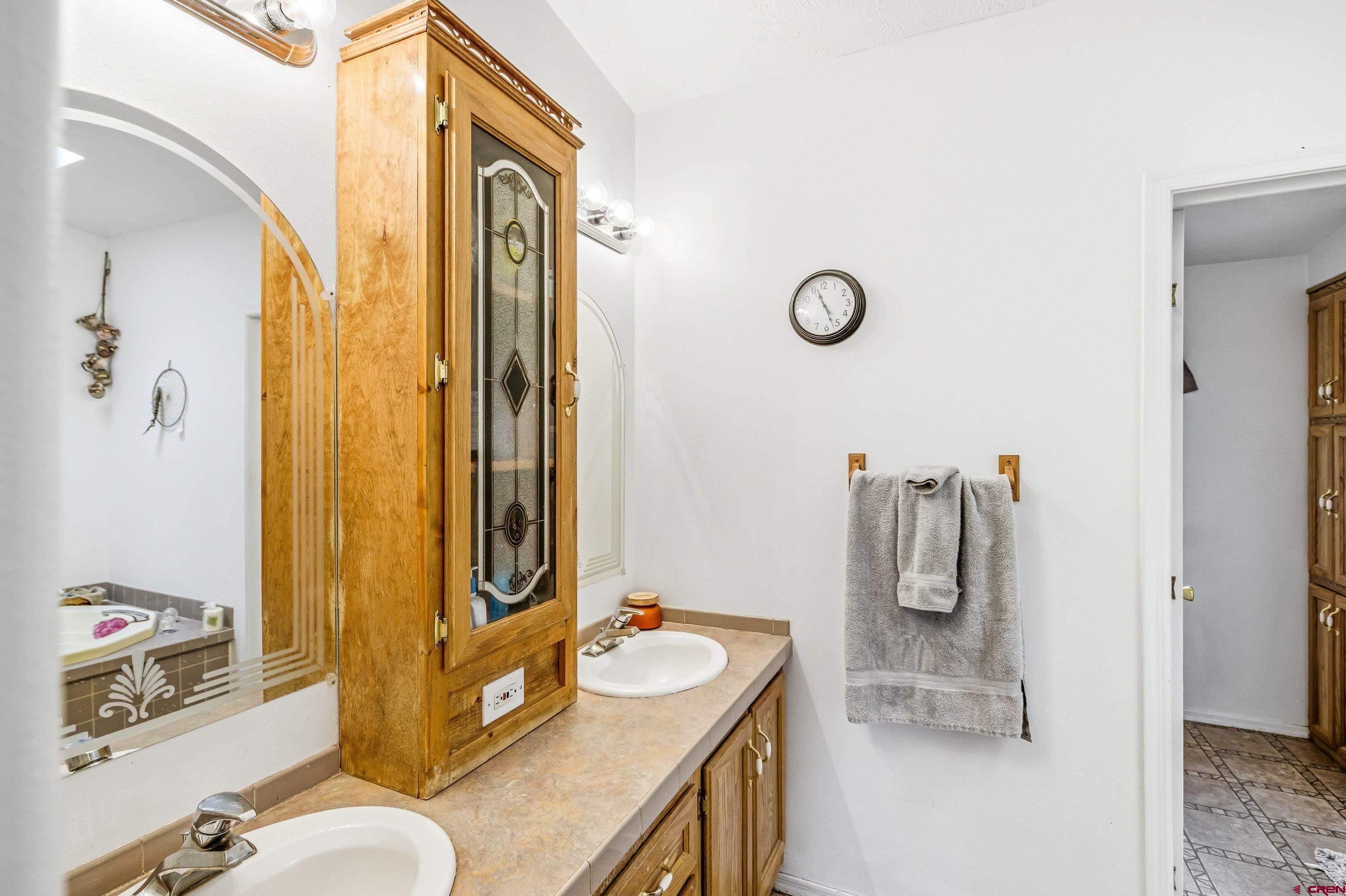 14414 G Road Delta, CO 81416 - Photo 11 of 39 a bathroom with a sink a mirror and a shower