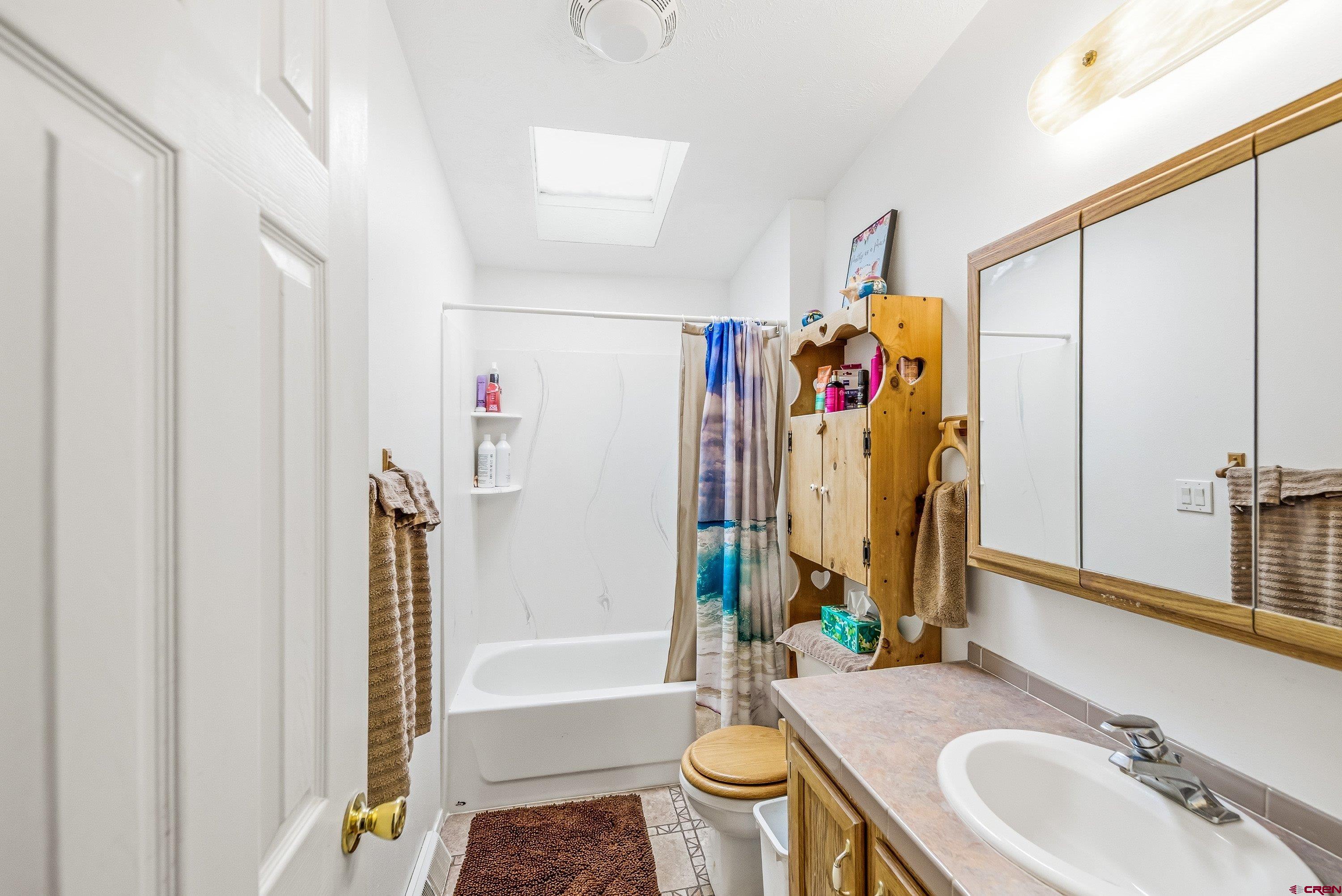 14414 G Road Delta, CO 81416 - Photo 14 of 39 a bathroom with a sink mirror toilet and bathtub