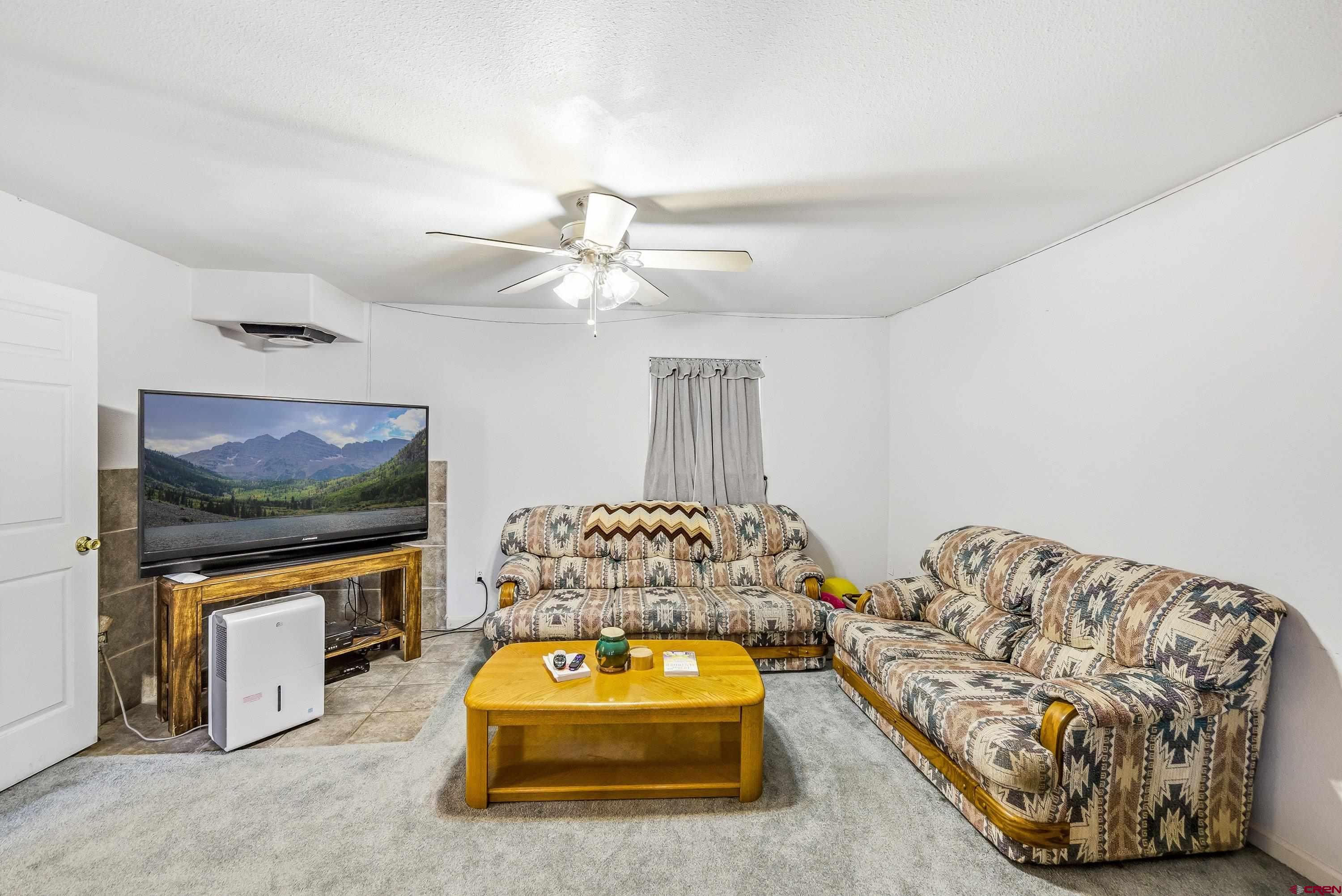 14414 G Road Delta, CO 81416 - Photo 18 of 39 a living room with furniture and a flat screen tv